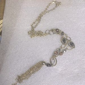 Large hanging gold tone necklace with reflective beads and gold tassels